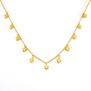 Detailed view of the gold heart pendant necklace with multiple 3D charms on a white surface