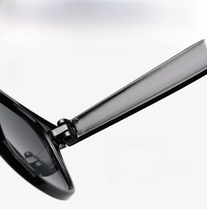 Macro detail of high-quality metal hinge construction on retro black sunglasses frame