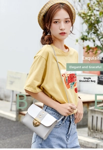 Detail of color-block crossbody bag with gold metal twist lock and gray and white leather