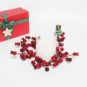 Christmas red berry berry wreath with LED candle in glass and festive gift box decor