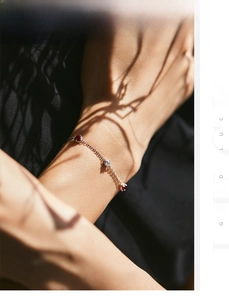 Macro shot of s925 silver bracelet with red and white gemstones on woman wrist