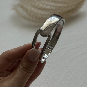 Close-up of silver multilayer beaded bracelet with high-gloss finish and clasp detail