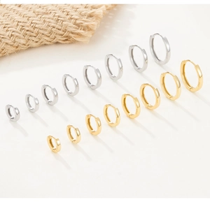 Close-up showing various sizes of polished S925 sterling silver hoop earrings in gold and silver