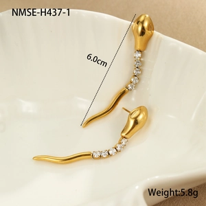 Detail view of 6.0cm gold snake earrings with sparkling rhinestones on a white shell tray