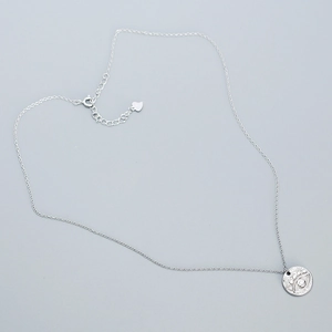 Detailed macro shot of 925 sterling silver evil eye pendant and delicate O-chain