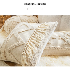 Detail of bohemian cream fringe pillow covers with textured geometric weaving patterns
