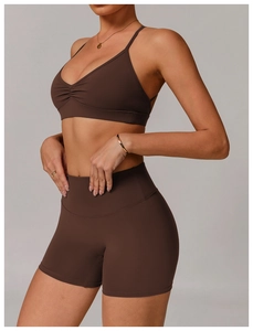Detail view of coffee brown quick-dry V-neck sports bra and high-waisted shorts set