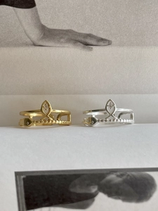 Detail of minimalist S925 silver fish-shaped rings in gold and silver with cubic zirconia