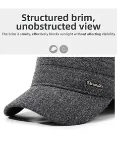 Macro detail of dark grey flat cap showing metal logo and sturdy sunshade brim texture