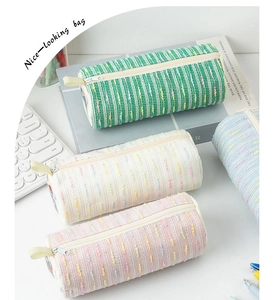 Colorful knitted texture pencil cases in pastel green, cream, pink, and light blue colors