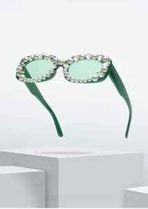 Detail of square green frame sunglasses with inlaid pearls and colorful rhinestones