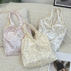 Detailed view of floral bear print satin tote bags with glossy velvet texture