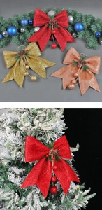 Detail of Christmas bow with pine cones and berries on a snowy pine tree branch