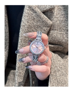 Close-up of elegant silver steel watch for women with pink dial and sparkling rhinestones