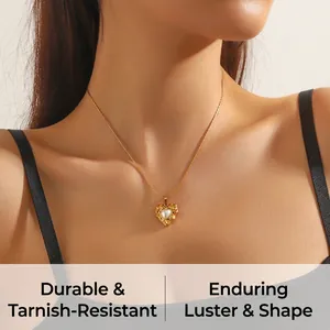 Detail shot of heart pearl pendant necklace worn by a model in warm soft lighting