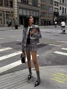 Chic gray plaid suit set featuring slim-fit blazer and pleated mini skirt for women