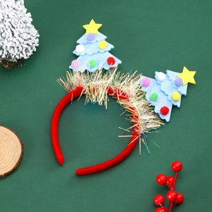 Close-up of red and blue Christmas tree headband with sequins and colorful pom-poms