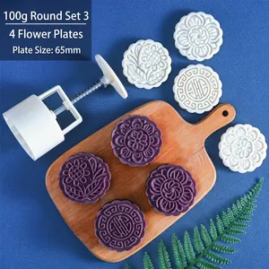 Detail view of 100g round mooncake mold set with four floral stamps and press tool
