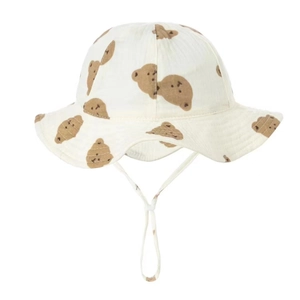Detail of baby cotton bucket hat with brown bear print and soft chin strap ties