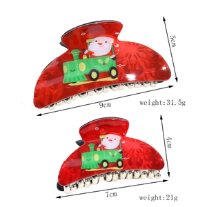 Detail showing two red Santa Claus hair claws with dimensions and weight info