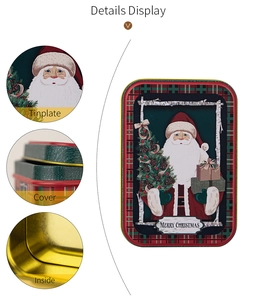 Detail view of festive tinplate Christmas boxes with Santa patterns and golden interior