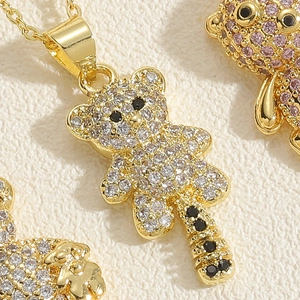 Macro view of teddy bear pendant featuring micro-pave white and pink zircon setting