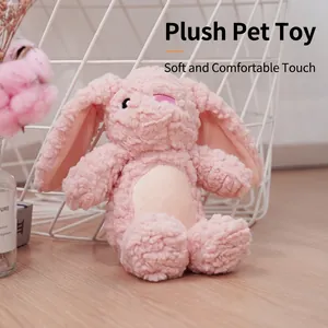 Pink plush rabbit pet toy for small dogs, soft fleecy material on wooden floor