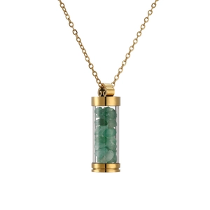 Detail of a golden perfume bottle pendant with green crushed stones on a gold chain