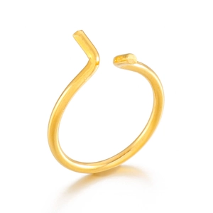 Macro shot of minimalist gold geometric open ring with polished curved metal finish