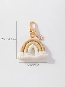Handmade rainbow keychain detail with cotton rope tassels and gold metal hook