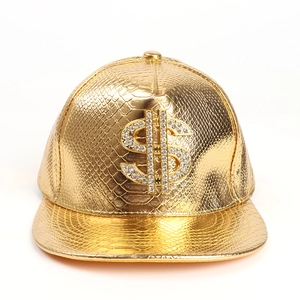 Detailed macro view of gold crocodile texture cap with sparkling dollar sign rhinestones