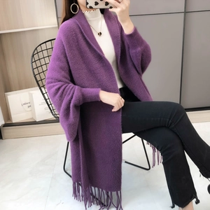 Close-up of the elegant purple knit shawl with detailed fringe and soft texture