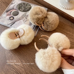 Maillard style plush pompom hair claw clip in beige and brown for elegant hairstyles