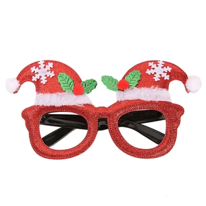 Detail of red glitter Christmas glasses frame with Santa hat design and white snowflake patterns