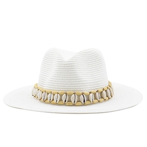 Detail of white woven straw hat with wooden beads and seashells decoration band