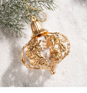 Close-up of golden hollow metal Christmas star ornament with leaf details on snow