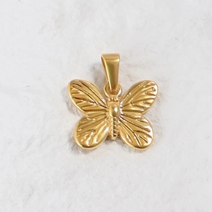 Detailed close-up of a 24K gold-plated butterfly pendant with intricate wing textures