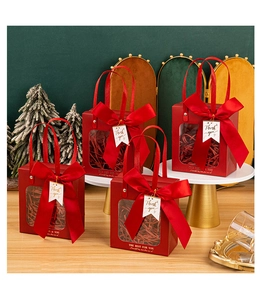 Detail of red gift bag with transparent window, satin ribbon and Thank You tag