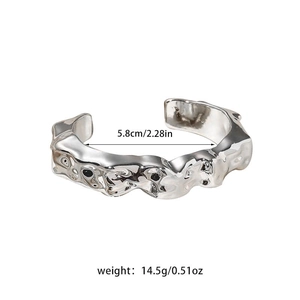 Detailed view of silver irregular textured cuff bracelet with size and weight specs