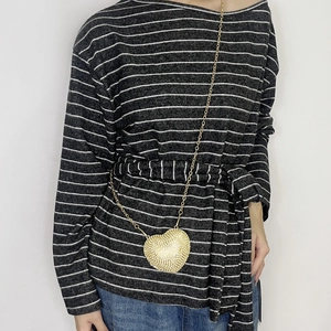 Close-up of a gold heart-shaped rhinestone mini crossbody bag with a chain strap