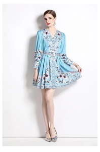 Detail of light blue floral dress with deep V-neck and matching belt with square buckle