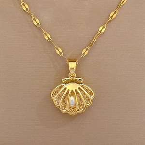 Detailed view of hollow shell pendant with pavé crystals and central white pearl