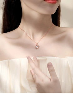 Detailed view of rose gold necklace featuring a sunflower pendant with dancing zircon stone