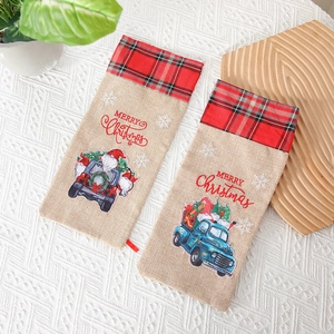 Linen Christmas wine gift bags with festive truck and plaid patterns on a white cloth