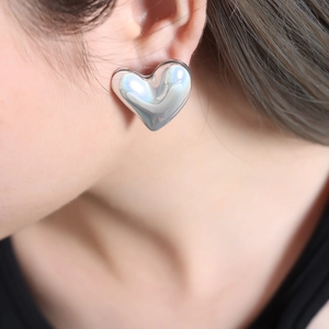 Elegant silver heart-shaped stainless steel earrings with a polished iridescent finish
