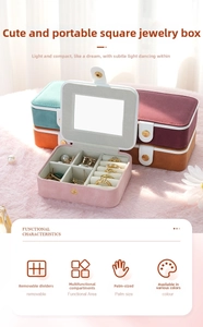 Detailed internal view of portable suede jewelry box featuring mirrors and compartments