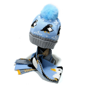 Winter knit hat and scarf set with blue penguin jacquard pattern and fluffy pom-pom