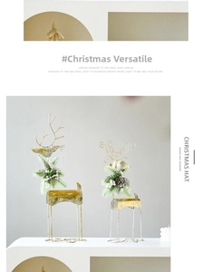 Detail of gold metal reindeer set with festive pine needles, white berries and cones