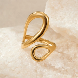 Close-up of a twisted 18k gold stainless steel ring on white crystal stones