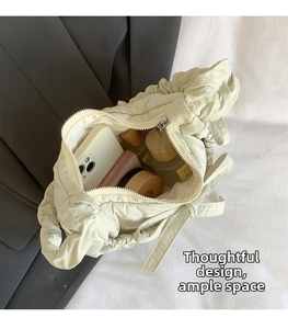 Interior view of pleated cloud bag showing ample storage space for phone and makeup